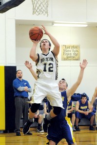 Clallam Bay's Ryan McCoy (12) scores in front of Crescent's Eli Williams. (Lonnie Archibald/for Peninsula Daily News)