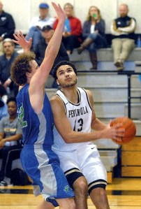 Peninsula's Malik Mayeux ducks into the lane around the defense of Edmonds' Devin Price. Mayeux led the Pirates in scoring with 16 points. (Keith Thorpe/Peninsula Daily News)