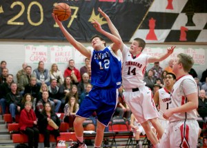 Chimacum's James Porter drives to the basket while defended by Port Townsend's Berkley Hill (14). (Steve Mullensky/for Peninsula Daily News)