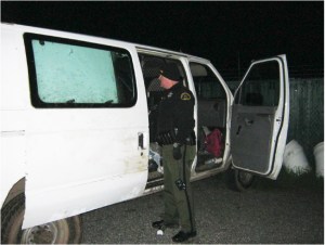 Clallam County Sheriff's Deputy Don Kitchen recovers property from the stolen van. (Sgt. Randy Pieper/Clallam County Sheriff's Office)