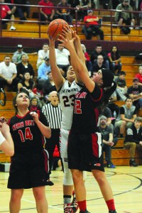 Neah Bay's Vonte Aguirre (12) challenges Taholah's Marquel Waugh for the rebound during a Class 1B basketball regional round game at W.F. West High School in Chehalis. Also in on the action is Neah Bay's Holly Greene (14). (Lonnie Archibald/for Peninsula Daily News)