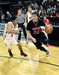 Neah Bay senior Ryan Moss drives the baseline against Taholah junior Brett Orozco during the second quarter of Thursday's 1B state tournament contest. (Roger Harnack/The Daily Sun News)