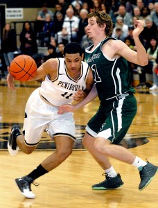 Peninsula's Deonte Dixon puts a shoulder into Chemeketa's Jack Frazier. (Keith Thorpe/Peninsula Daily News)
