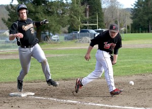 Quilcene's Nathan Weller reaches first base safely as the ball gets by Port Townsend first baseman Cody Morgan-Erfle. (Steve Mullensky/for Peninsula Daily News)
