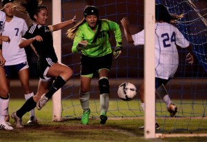Mililani's Jayna Morikawa (11) watches as the ball crosses the goal line as Pearl City goalkeeper Sydney Young (32) looks on during a match in February. Morikawa