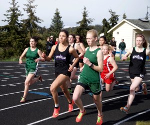 Sequim's Waverly Shreffler and Port Angeles' Gracie Long run side by side at the start of the girls 1