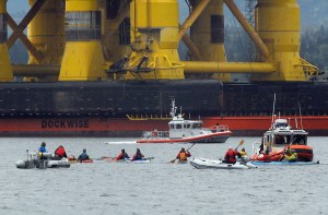 U.S. Coast Guard patrol boats warn protesters in kayaks not to intrude upon the safety zone imposed around the Polar Pioneer and Blue Marlin in Port Angeles Harbor. (Keith Thorpe/Peninsula Daily News)