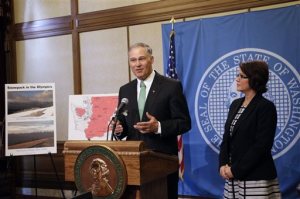 Gov. Jay Inslee talks to the media about his statewide drought emergency as state ecology director Maia Bellon looks on