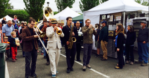 Transcendental Brass Band members make their way through vendors at the Juan de Fuca Festival before their  performance Saturday. (Paul Gottlieb/Peninsula Daily News (Click on image to enlarge))
