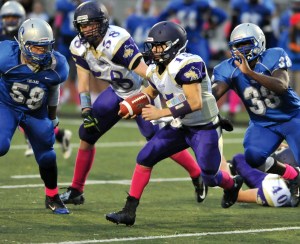 Sequim quarterback Miguel Moroles (15) was as dangerous on the run as he was throwing the ball. Moroles was named to the Olympic League first team and has been selected as the All-Peninsula Football Offensive MVP. (Jeff Halstead/for Peninsula Daily News)