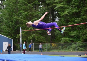Sequim's Jackson Oliver clears the bar in the high jump during the District 2/3 championship meet at North Mason High School. (Dave Shreffler/for Peninsula Daily News)