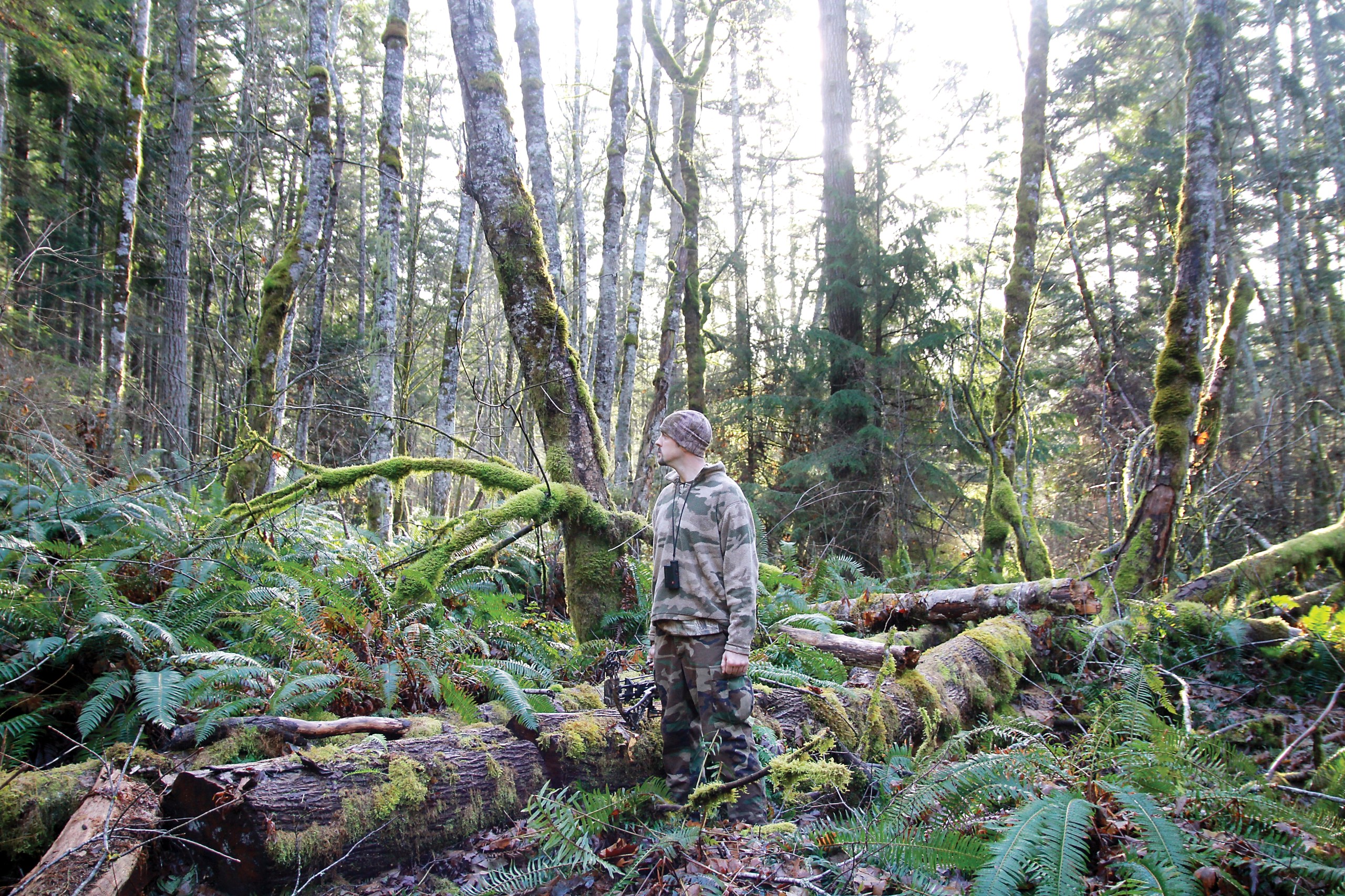 Deputy Adam Newman searching for a spot to practice his archery in the forest on “Dark Woods Justice.” (Discovery Channel)