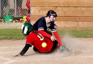 Jim's Pharmacy's Taylor Worthington slides into home as a throw bounces away from Paint and Carpet Barn pitcher Destiny Smith in the 12U softball city championship game at Lincoln Park in Port Angeles. Paint and Carpet won 14-2. (Dave Logan/for Peninsula Daily News)