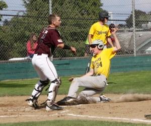 Justin Porter of the Olympic Crosscutters slides safely into home as Montesano catcher Nate Olson waits for the throw to the plate. (Dave Logan/for Peninsula Daily News)