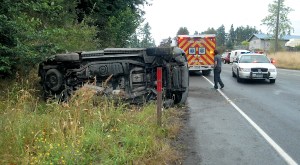 Ford Explorer on its side Friday near the Tumwater Truck Route on-ramp in Port Angeles. Keith Thorpe/Peninsula Daily News  (Click to enlarge photo)