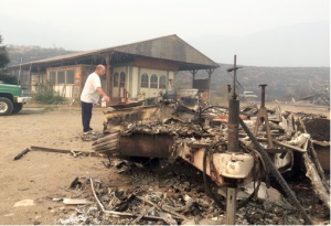 Steve Surgeon surveys the ruins after he lost everything he owned except his home in a wildfire on the outskirts of Okanogan on Sunday (Aug. 23). He said he stayed as the fire raced over a ridge and barreled down toward his home