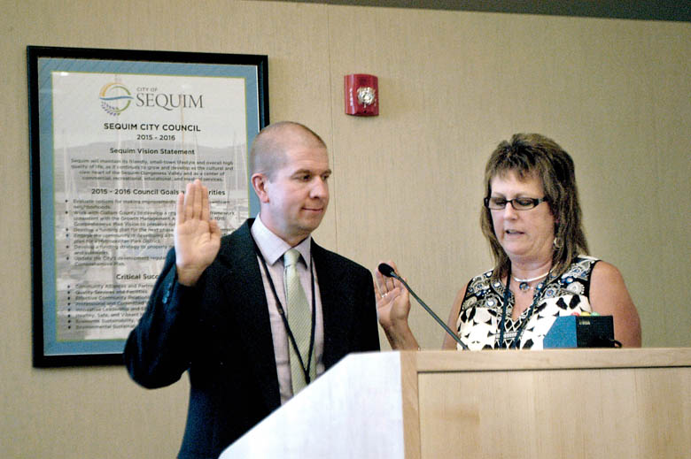 Charlie Bush is sworn in as the new Sequim city manager Monday evening by Karen Kuznek-Reese