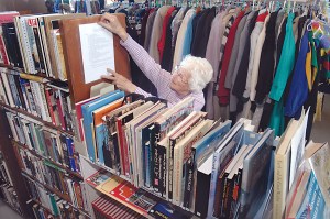 Clallam County Historical Society volunteer Dona Cloud of Port Angeles posts an information sheet at the Lincoln School building in Port Angeles