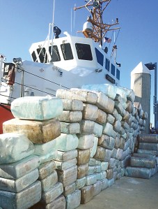 Bales of interdicted marijuana are stacked on the pier in San Diego in front of the Coast Guard cutter Adelie last Saturday. Coast Guard