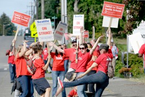 Teachers dance and cheer next to a picket line Wednesday in front of Chief Sealth International High School in Seattle. The Associated Press
