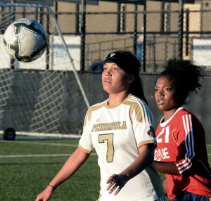 Peninsula's Hoku Afong receives the ball against the defense of Bellevue's Porsche Jennings. Rick Ross/Peninsula College Athletics