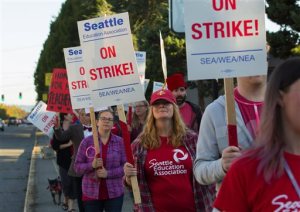 Striking teachers picket in front of schools in West Seattle on Thursday. The Associated Press (Click on image to enlarge)