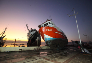 A fishing boat was tossed onto a dock after it was lifted by an earthquake-triggered tsunami in Coquimbo