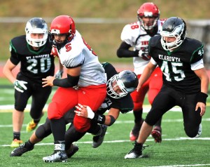 Port Townsend quarterback David Sua (5) runs through a tackle by Klahowya's Lucas Weaver as Jacob Sargent (20) and Tyler Vandergriff (45) close in. Jeff Halstead/for Peninsula Daily News