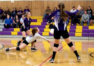 Quilcene's Alex Johnsen (white jersey) digs the ball during the Rangers' three-set sweep of Seattle Lutheran in Quilcene on Tuesday. The Rangers (2-0