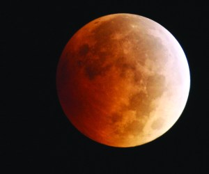 The moon takes on a reddish cast during a total lunar eclipse Oct. 8