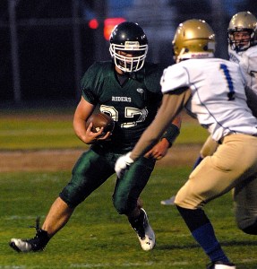 Port Angeles' Jace Lausche looks for a way around Bremerton's Tony Watson during the second quarter of the Roughriders' 23-7 loss at Civic Field. Keith Thorpe/Peninsula Daily News