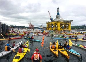 Activists in kayaks and other vessels who oppose Royal Dutch Shell's plans to drill for oil in the Arctic Ocean surround Shell's Polar Pioneer drilling rig docked in Elliott Bay