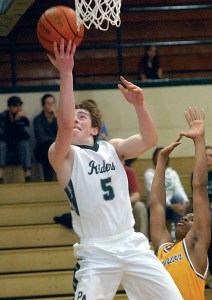 Port Angeles' Noah McGoff goes for the layup as Bremerton's Phillip Grant defends during the Roughriders' 57-54 win against the Knights at Port Angeles High School. (Keith Thorpe/Peninsula Daily News)