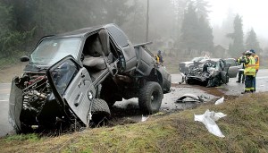 Law enforcement and rescue personnel survey the scene of a two-vehicle head-on collision on U.S. 101 east of Laird Road near Port Angeles on Wednesday.  Photo by Keith Thorpe/Peninsula Daily News ()
