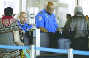 Transportation Security Administration agents check travelers identifications at a security check point area in Terminal 3 at OHare International Airport in Chicago in November.  The Associated Press ()