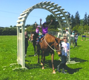 Riders Lily Robertson and Maddie Niemeyer learn confidence and balance as part of a Freedom Farms Mini Beats class. Theyre accompanied by Hoof Beat Club members Ben Robertson