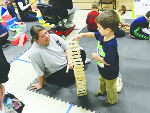 Kelli DeBoer builds a tower  with her 4&frac12;-year-old son Kawika at BlockFest program at Dry Creek Elementary School on Jan. 10.  —Photo by Michael McCarty ()