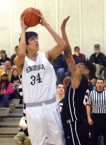 Peninsula's Jonah Cook aims for the hoop as Olympic's Cortavious Williams defends the lane. (Keith Thorpe/Peninsula Daily News)