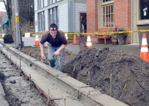 Robert Kinney of Sound Concrete Solutions of Port Townsend works on the replacement of a new Water Street sidewalk