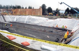 Construction crews work Friday on what will become a stormwater retention basin at the site of a new McDonalds restaurant undergoing reconstruction between First and Front streets at Penn Street in Port Angeles.  Keith Thorpe/Peninsula Daily News ()