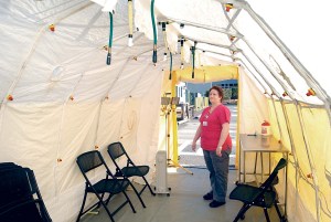Olympic Medical Center lab assistant Deana Heimbigner looks over an isolation tent near the hospital's emergency room in Port Angeles on Wednesday. The tent is for temporarily quarantines of incoming patients with measles to prevent the disease from entering the hospital. (Keith Thorpe/Peninsula Daily News)