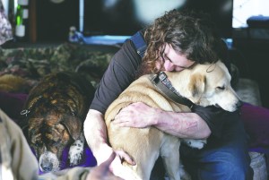 Joshua Madrid hugs his dog