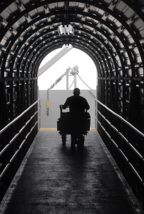 Cook Courtland Waldron pushes a cart of food supplies up the passenger ramp for the MV Coho on Friday. (Keith Thorpe/Peninsula Daily News)