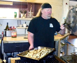 Zoogs Caveman Cookin Restaurant & Cave Lounge owner Bret Zoog Forsberg prepares for the lunch rush Wednesday.  Charlie Bermant/Peninsula Daily News ()