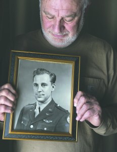 Al Paffenroth Jr. poses in his home March 17 with a photograph of his father Al Paffenroth Sr. in Tacoma.  Drew Perine/The News Tribune via AP ()