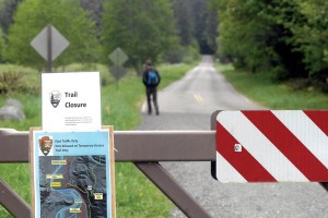 A trail closure sign and temporary trail map are affixed to a gate blocking Olympic Hot Springs Road into Olympic National Park in the Elwha Valley west of Port Angeles on Thursday.  Keith Thorpe/Peninsula Daily News ()