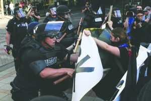 Protesters push the line that Seattle Police set up at the start of the march at Fourth Avenue and Pine during the annual May Day Anti-Capitalist protest and march Sunday in Seattle.  The Associated Press ()