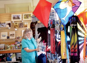 Volunteer Cathy Renskers stocks items in the newly relocated Fort Worden State Park gift shop near Port Townsend.  Charlie Bermant/Peninsula Daily News ()