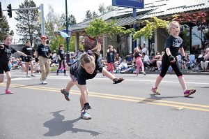 Azlynn Judd of Sequim Acrobatics does a cartwheel for the crowd as fellow acrobats Anna Geer