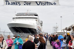 Volunteers from Port Angeles welcome passengers as they disembark from the cruise ship ms Statendam on Saturday. Photo by James Casey/Peninsula Daily News ()